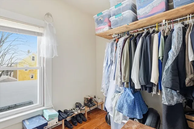 a view of walk in closet with clothes and shoes