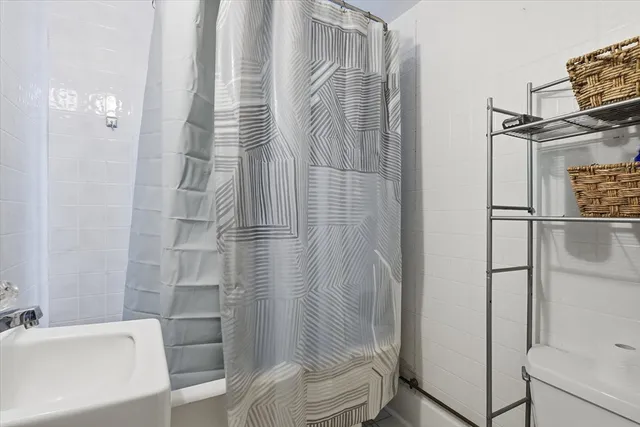 a bathroom with a shower and a sink
