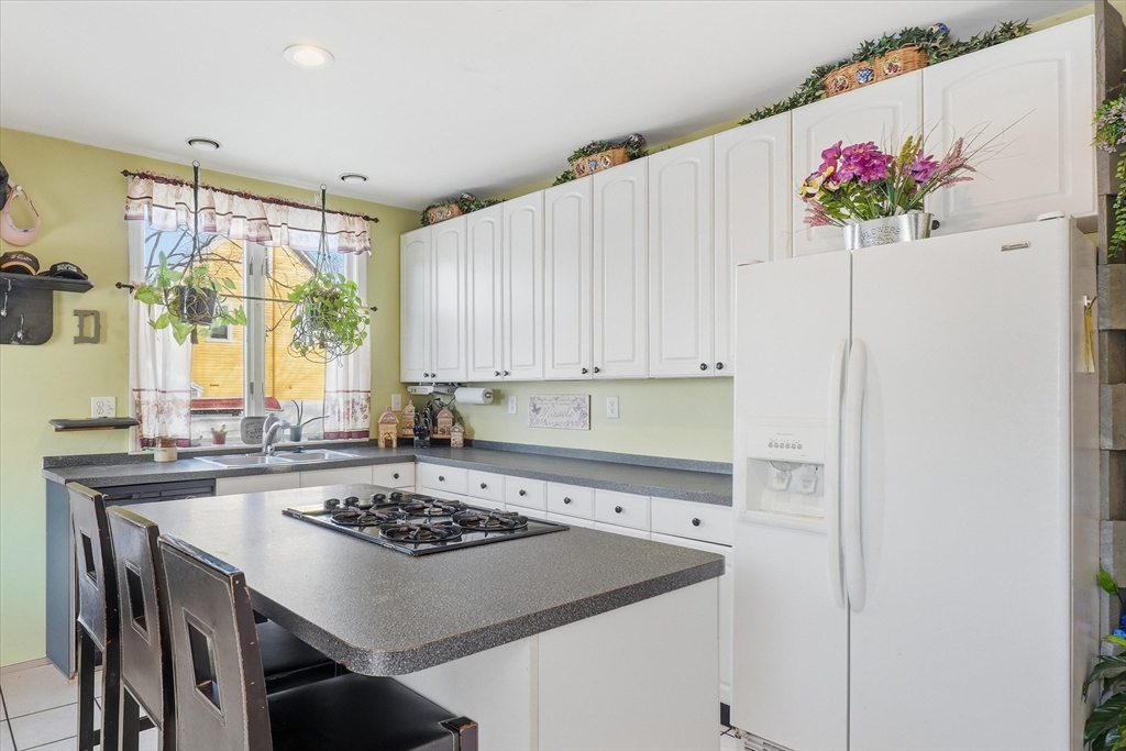 30-32 Walnut Street Maynard, MA 01754 - Photo 3 of 38 a kitchen with a stove a sink and cabinets