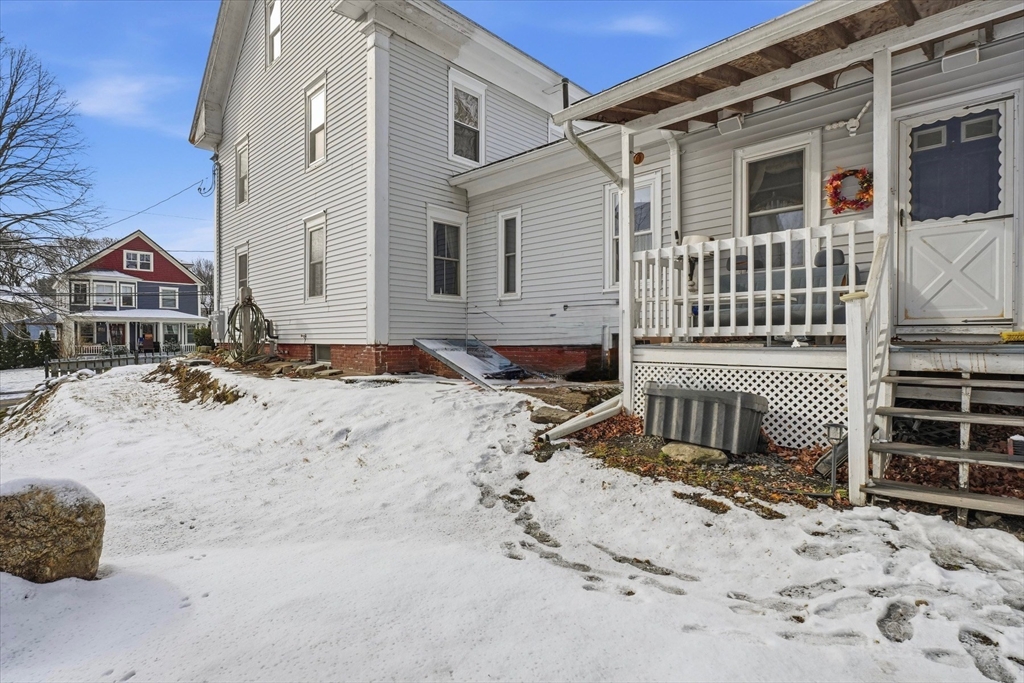 30-32 Walnut Street Maynard, MA 01754 - Photo 31 of 38 a front view of a house with a yard