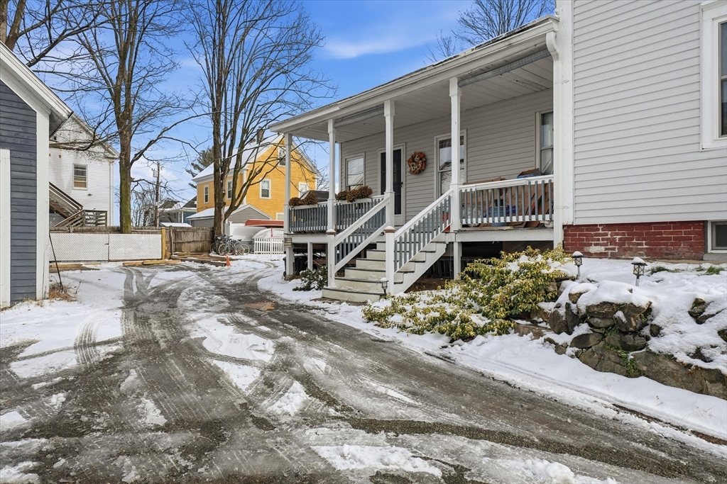 30-32 Walnut Street Maynard, MA 01754 - Photo 32 of 38 a house with trees in front of it