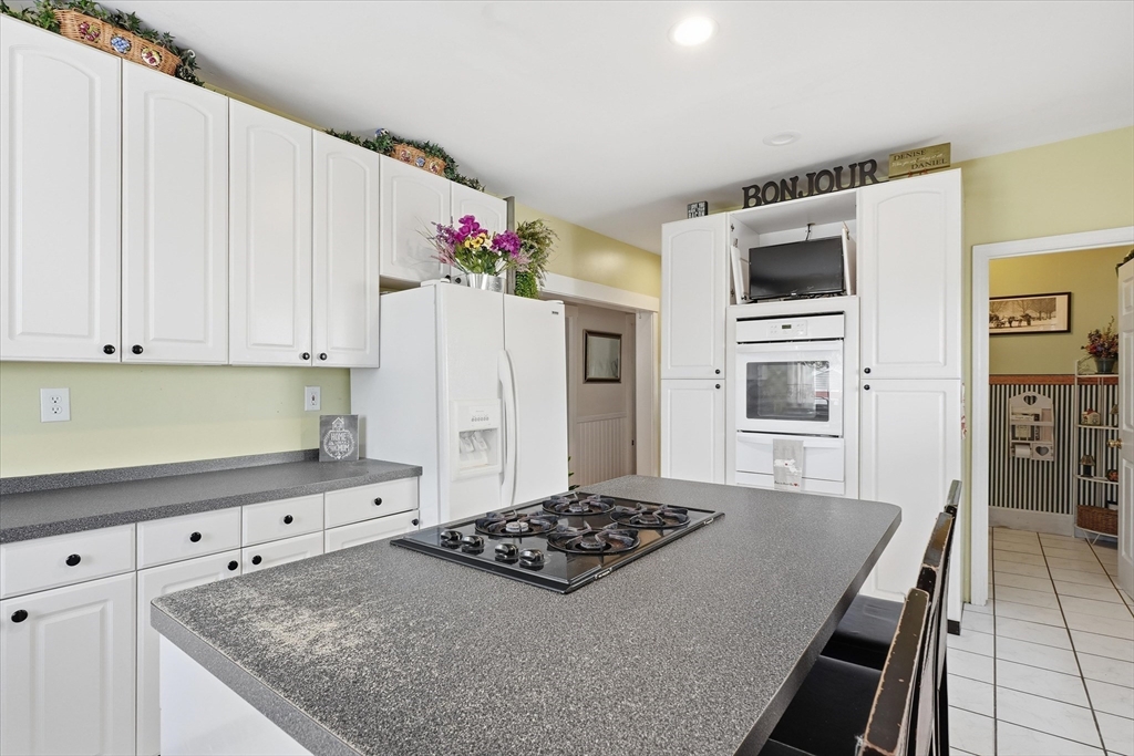 30-32 Walnut Street Maynard, MA 01754 - Photo 4 of 38 a kitchen with granite countertop a sink stove and refrigerator