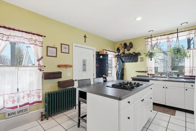 a kitchen with granite countertop a sink stove and refrigerator