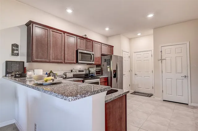 a kitchen with stainless steel appliances granite countertop a stove top oven a sink and dishwasher