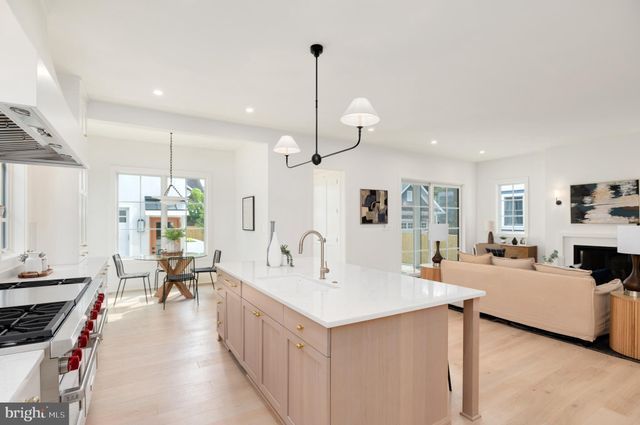 a living room with furniture fireplace and a large window