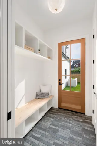 a living room with furniture and a mirror