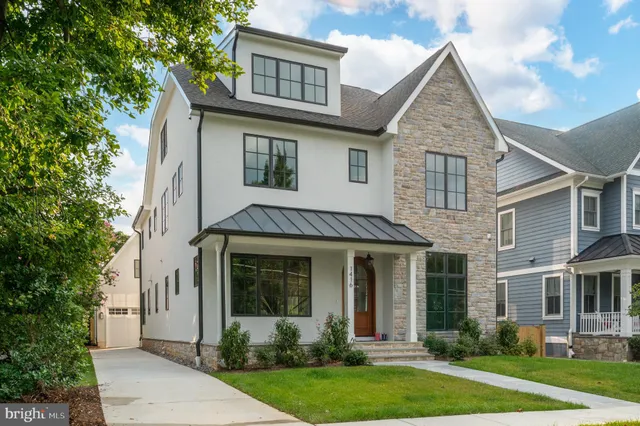 a very nice looking dining room with a large window and chandelier