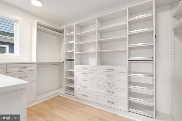 a bathroom with a toilet a sink a mirror and shower