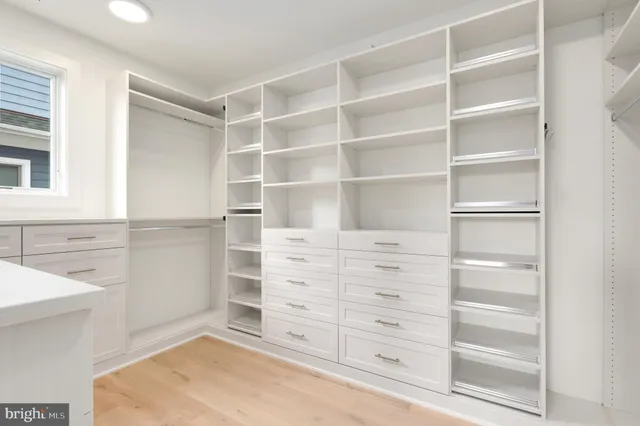 a bathroom with a toilet a sink a mirror and shower