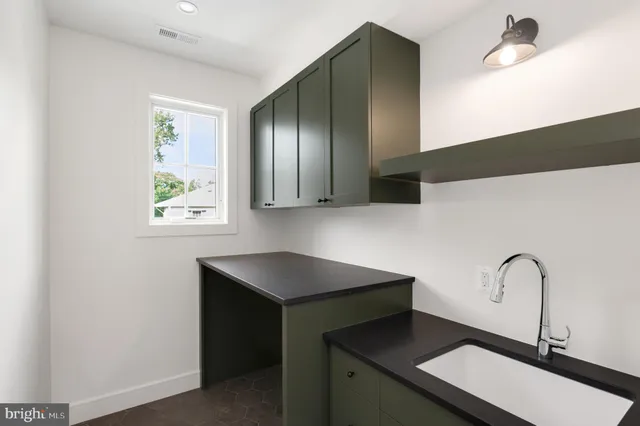 a bathroom with a sink a toilet a mirror and shower