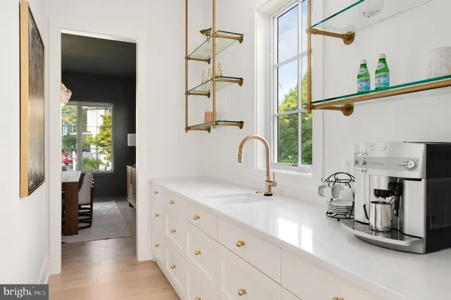 a kitchen with stainless steel appliances a stove a sink and a wooden cabinets