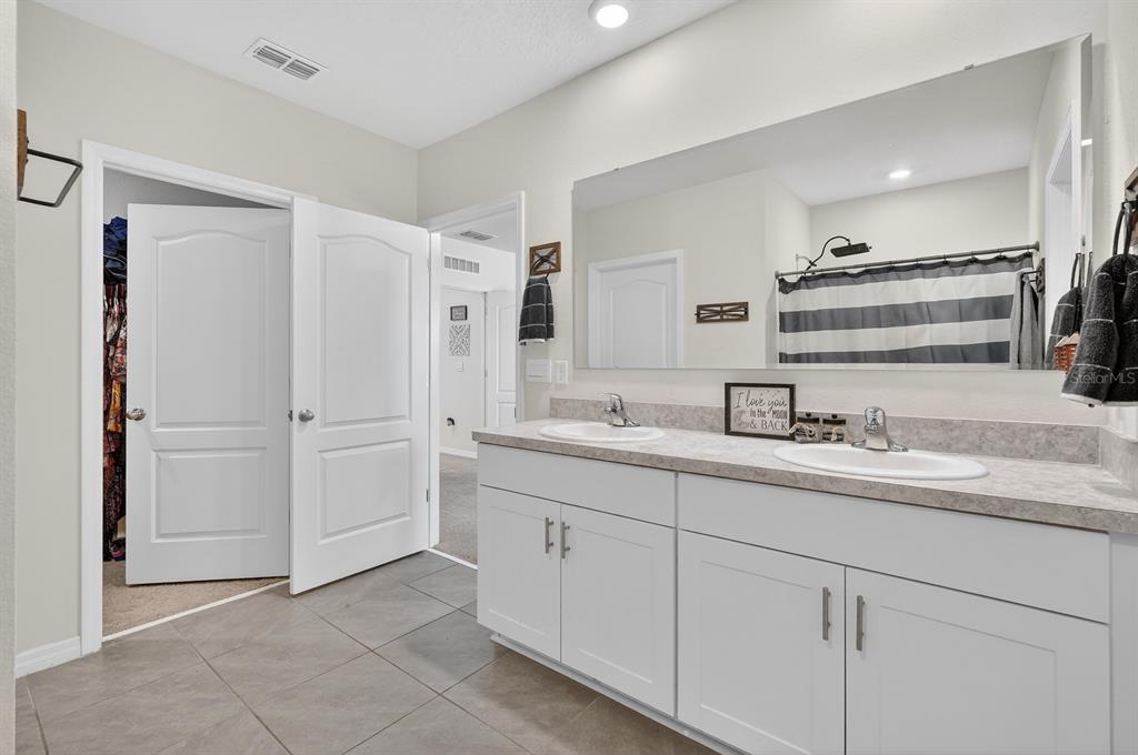 1809 Myrtlebrooke Drive Edgewater, FL 32141 - Photo 20 of 58 a bathroom with a sink and a mirror