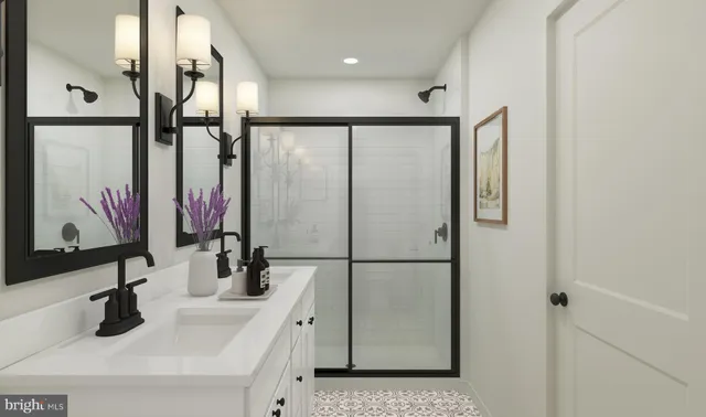 a bathroom with double vanity sinks and a mirror