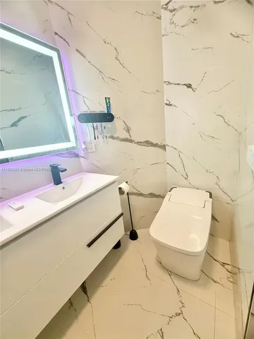 a bathroom with a sink a toilet and mirror