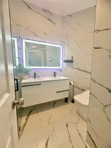 a bathroom with a tub sink and mirror