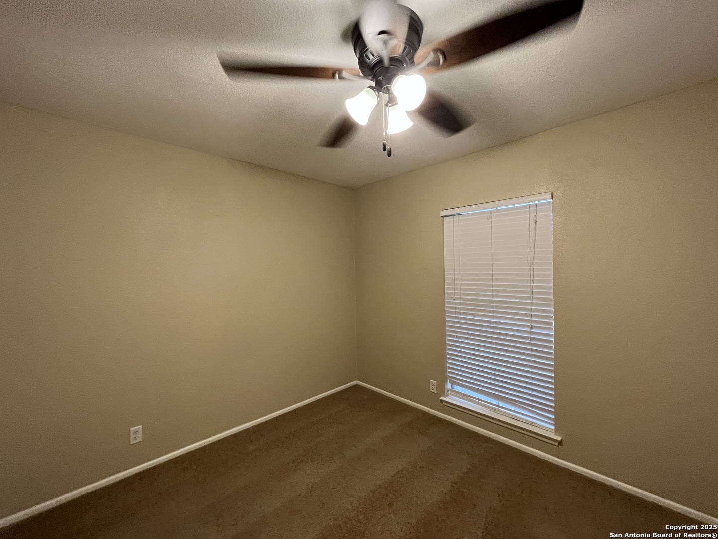 6522 Ridge Willow Drive San Antonio, TX 78233 - Photo 39 of 42 an empty room with a window and a fan