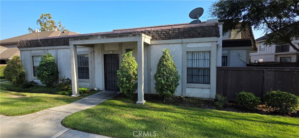 4823 Cobblestone Lane, Unit 24 Cypress, CA 90630 - Photo 1 of 26 front view of a house with a yard