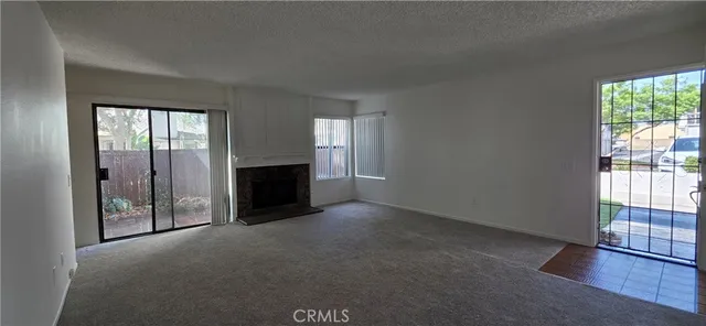 an empty room with wooden floor and fireplace