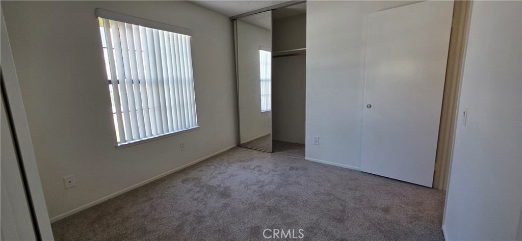 4823 Cobblestone Lane, Unit 24 Cypress, CA 90630 - Photo 4 of 26 an empty room with windows
