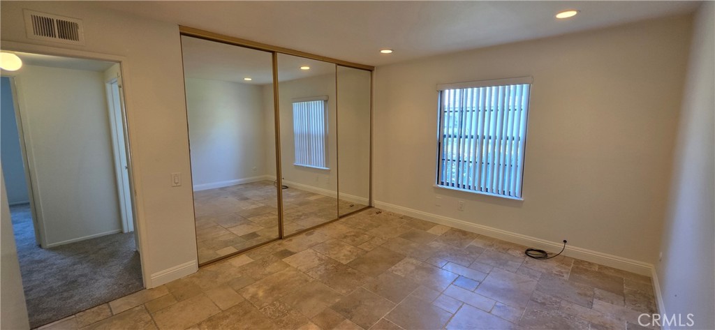 4823 Cobblestone Lane, Unit 24 Cypress, CA 90630 - Photo 10 of 26 a view of an empty room with glass door