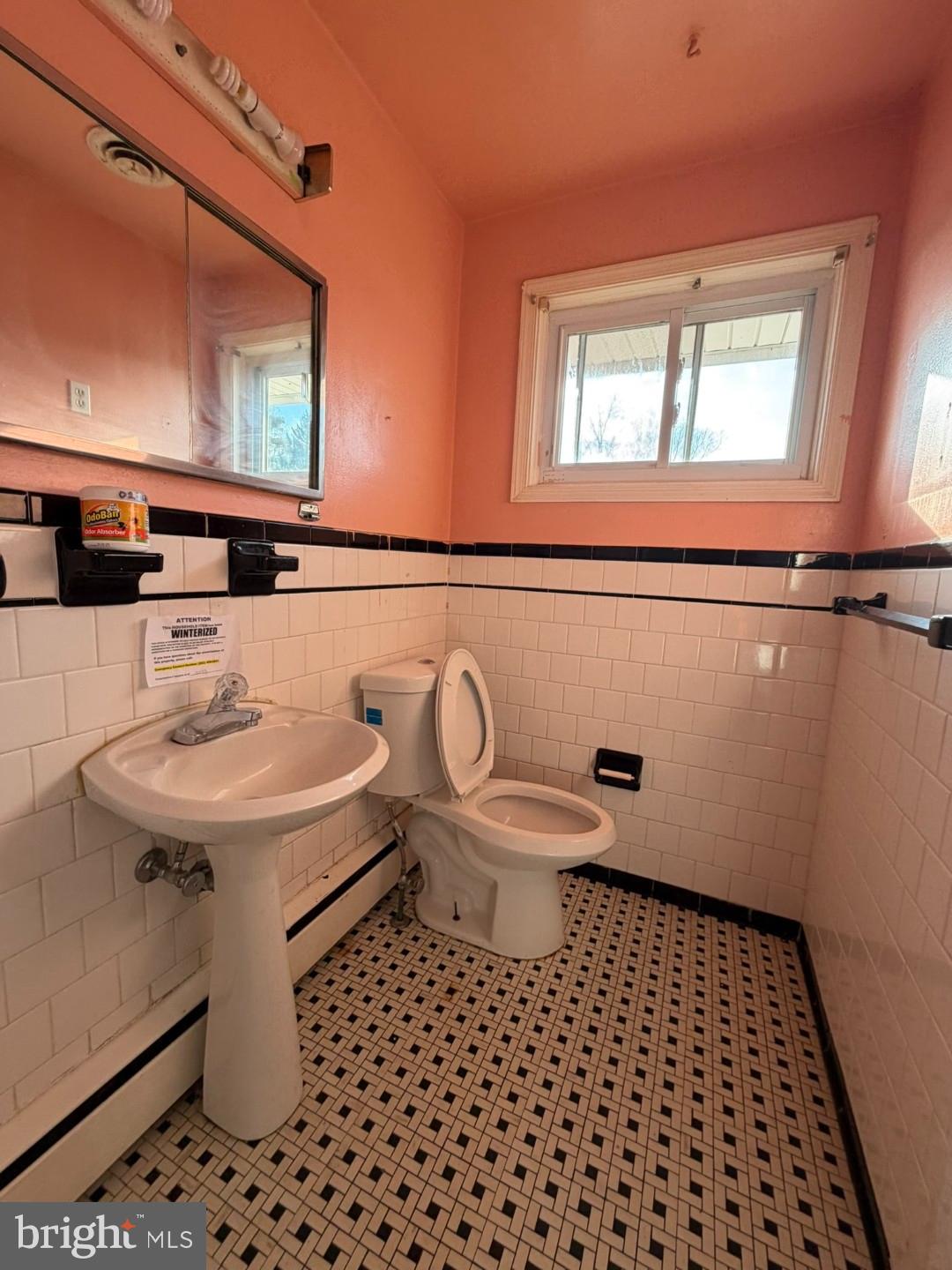 3829 Elmcroft Road Randallstown, MD 21133 - Photo 11 of 56 a bathroom with a sink a toilet and a mirror