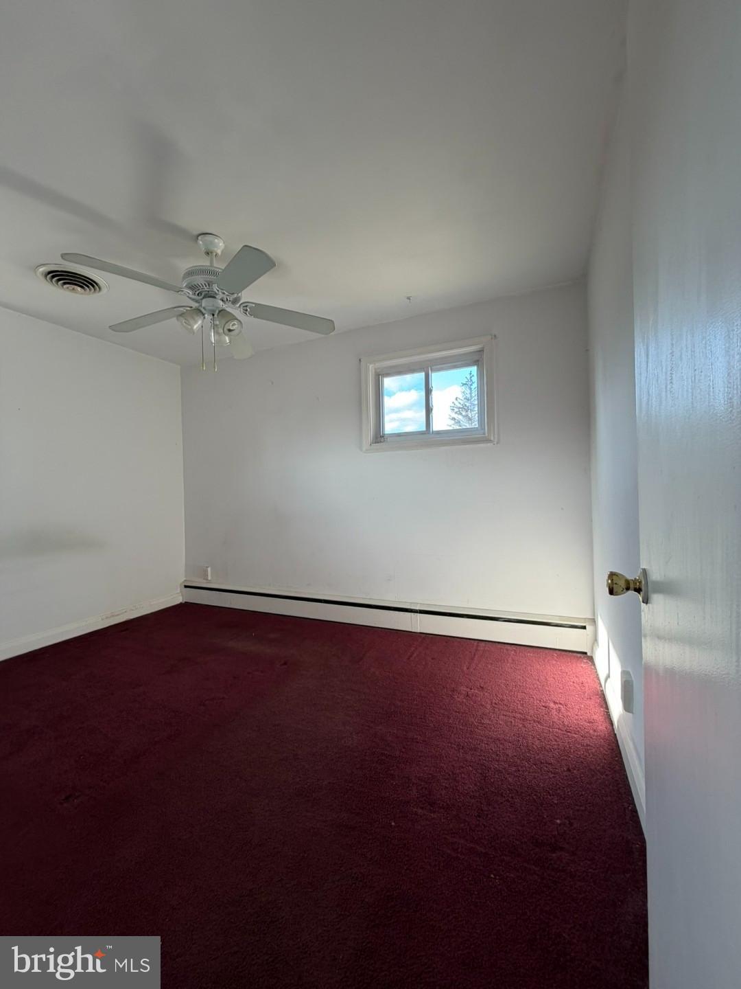 3829 Elmcroft Road Randallstown, MD 21133 - Photo 13 of 56 an empty room with a ceiling fan and hardwood floor