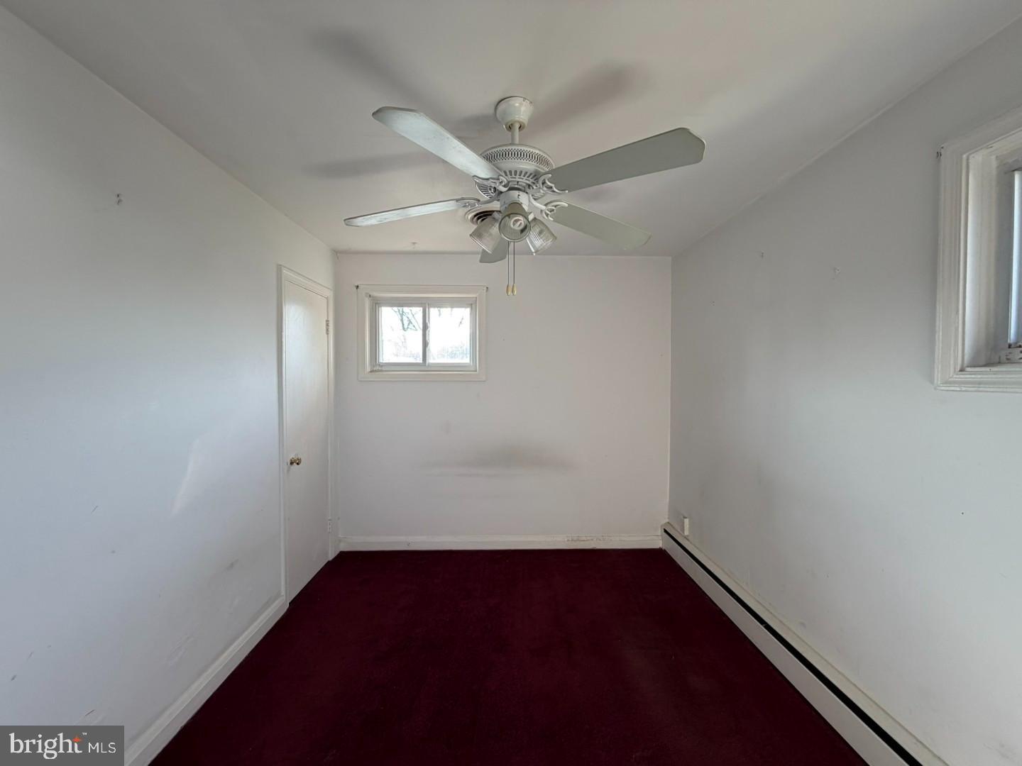 3829 Elmcroft Road Randallstown, MD 21133 - Photo 14 of 56 an empty room with a window and a ceiling fan