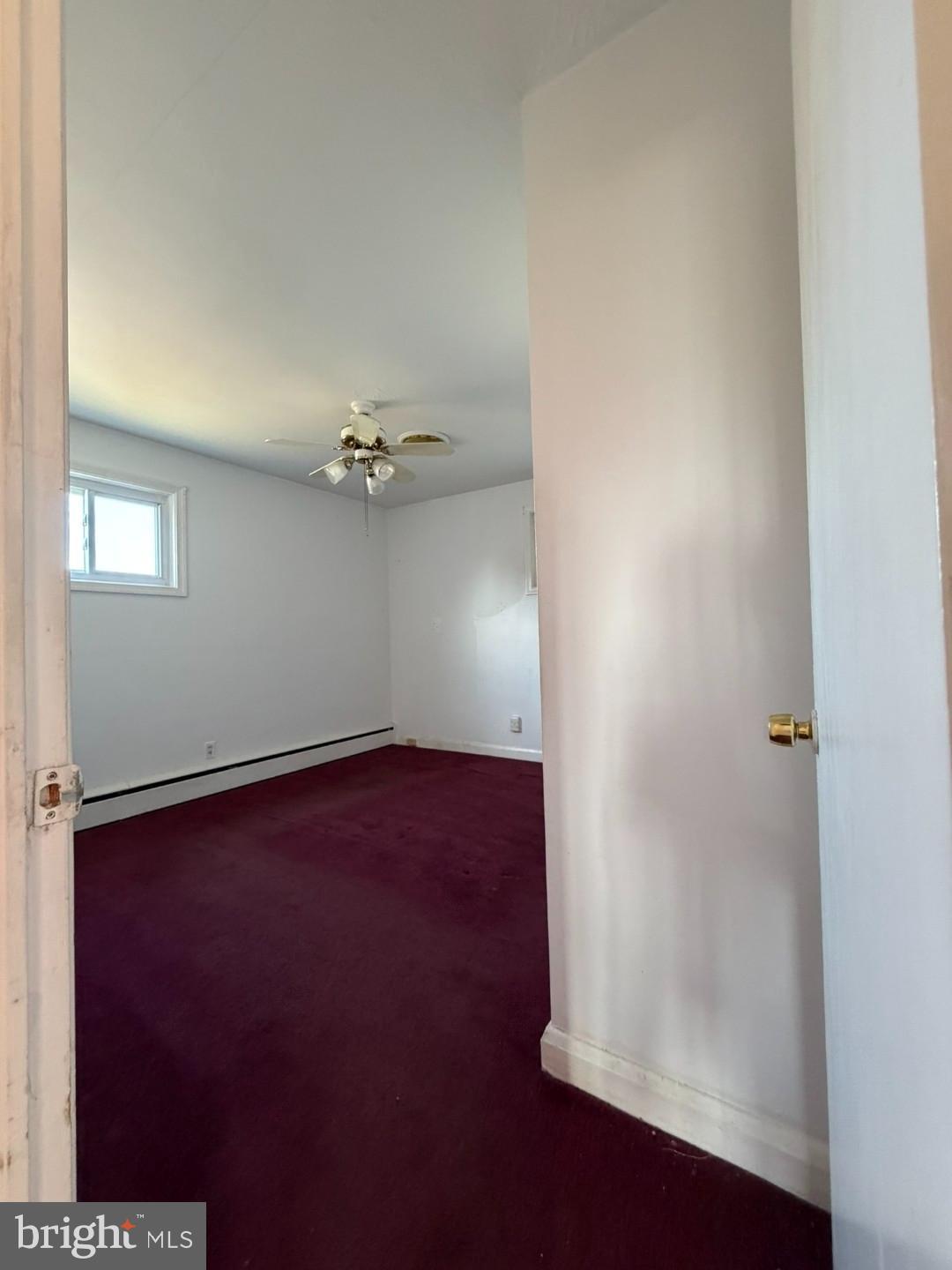 3829 Elmcroft Road Randallstown, MD 21133 - Photo 19 of 56 an empty room with a potted plant and wooden floor