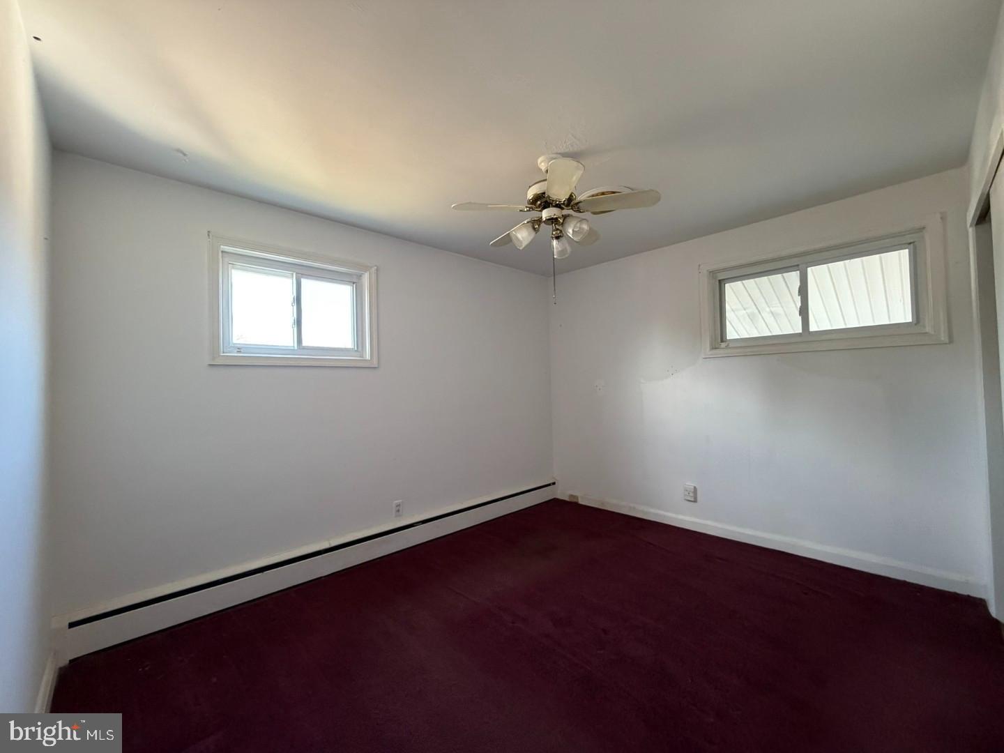 3829 Elmcroft Road Randallstown, MD 21133 - Photo 21 of 56 an empty room with windows and fan