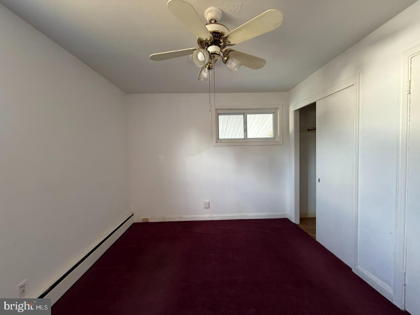3829 Elmcroft Road Randallstown, MD 21133 - Photo 22 of 56 an empty room with a chandelier fan and windows