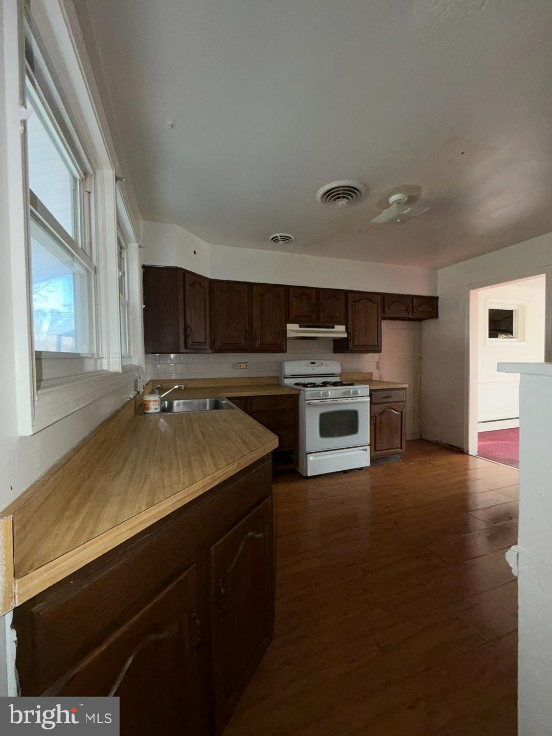 3829 Elmcroft Road Randallstown, MD 21133 - Photo 32 of 56 a kitchen with a sink appliances and cabinets