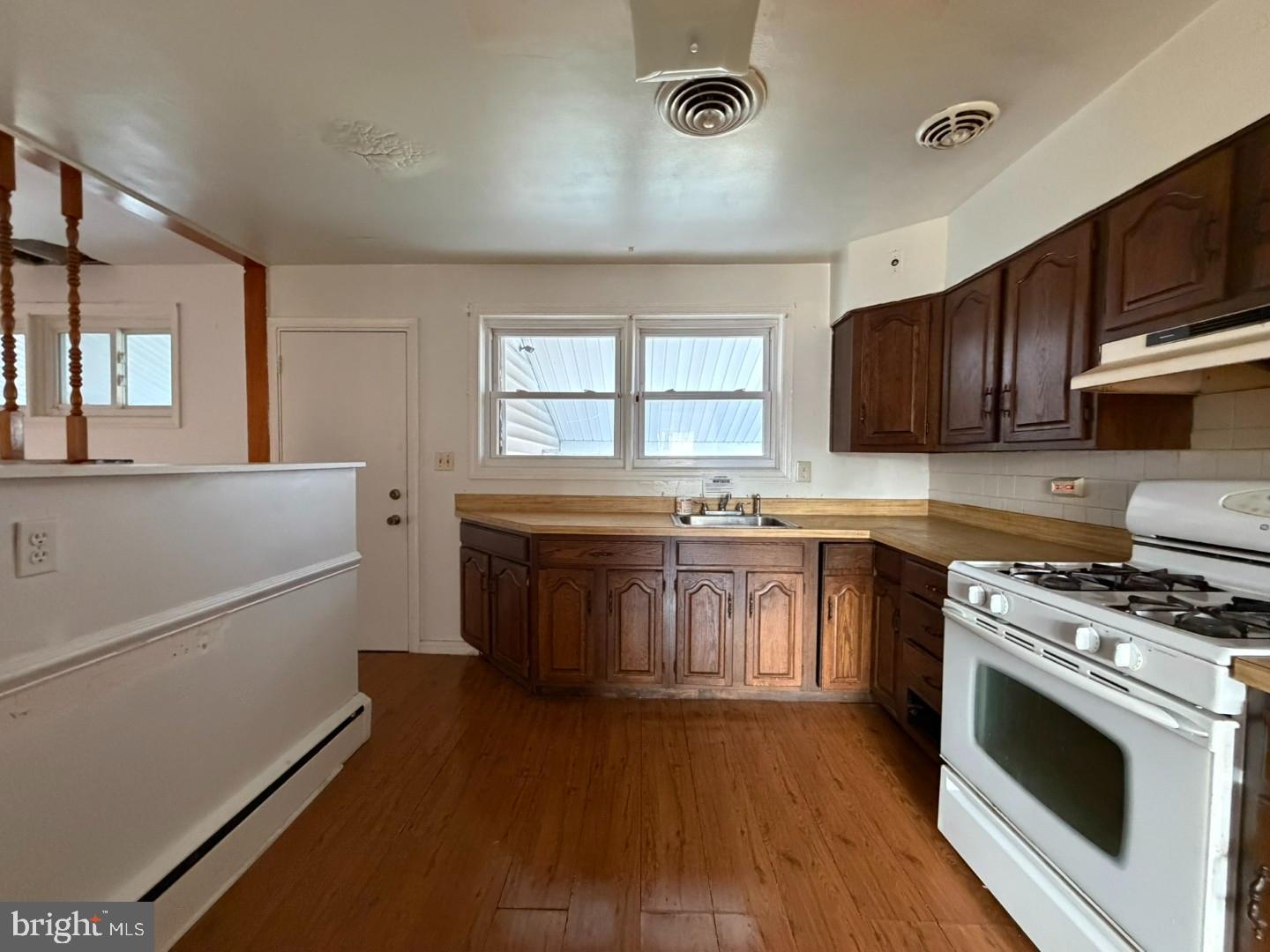 3829 Elmcroft Road Randallstown, MD 21133 - Photo 33 of 56 a kitchen with stainless steel appliances wooden cabinets and a stove top oven