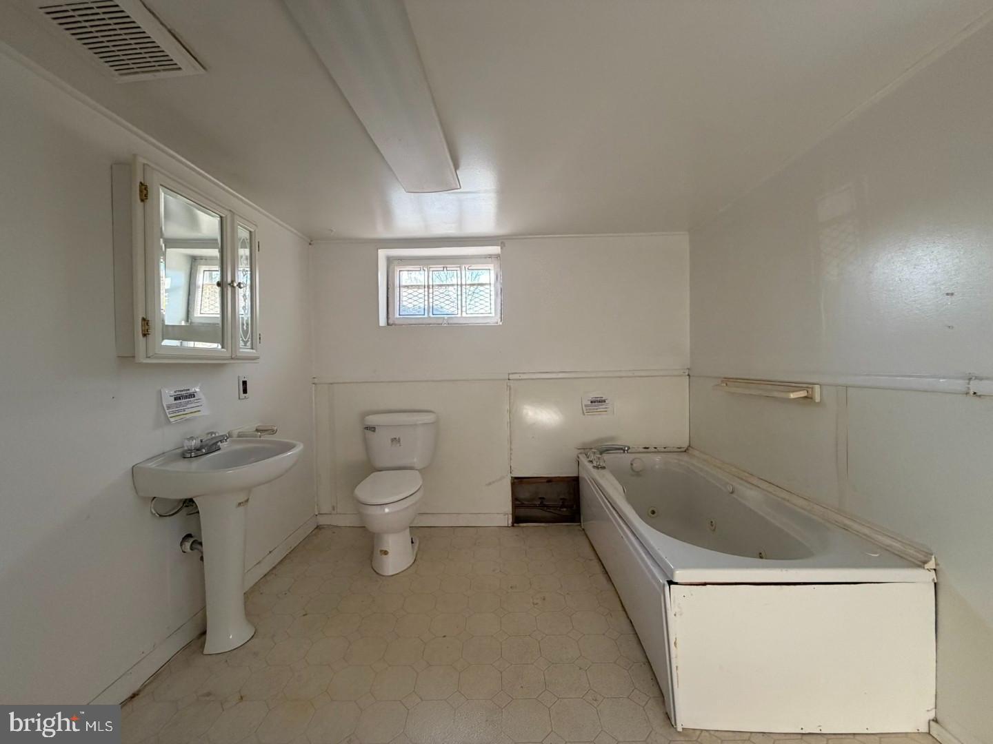 3829 Elmcroft Road Randallstown, MD 21133 - Photo 50 of 56 a bathroom with a toilet a sink and mirror