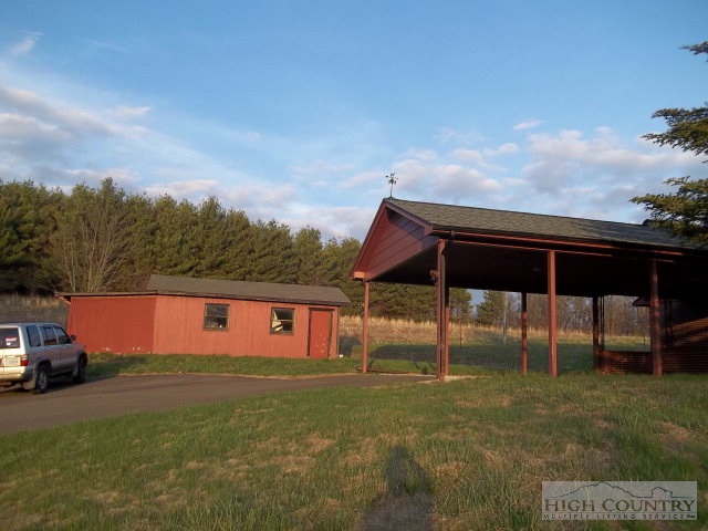 9432 Glade Valley Road Ennice, NC 28623 - Photo 3 of 7 a backyard of a house with table and chairs