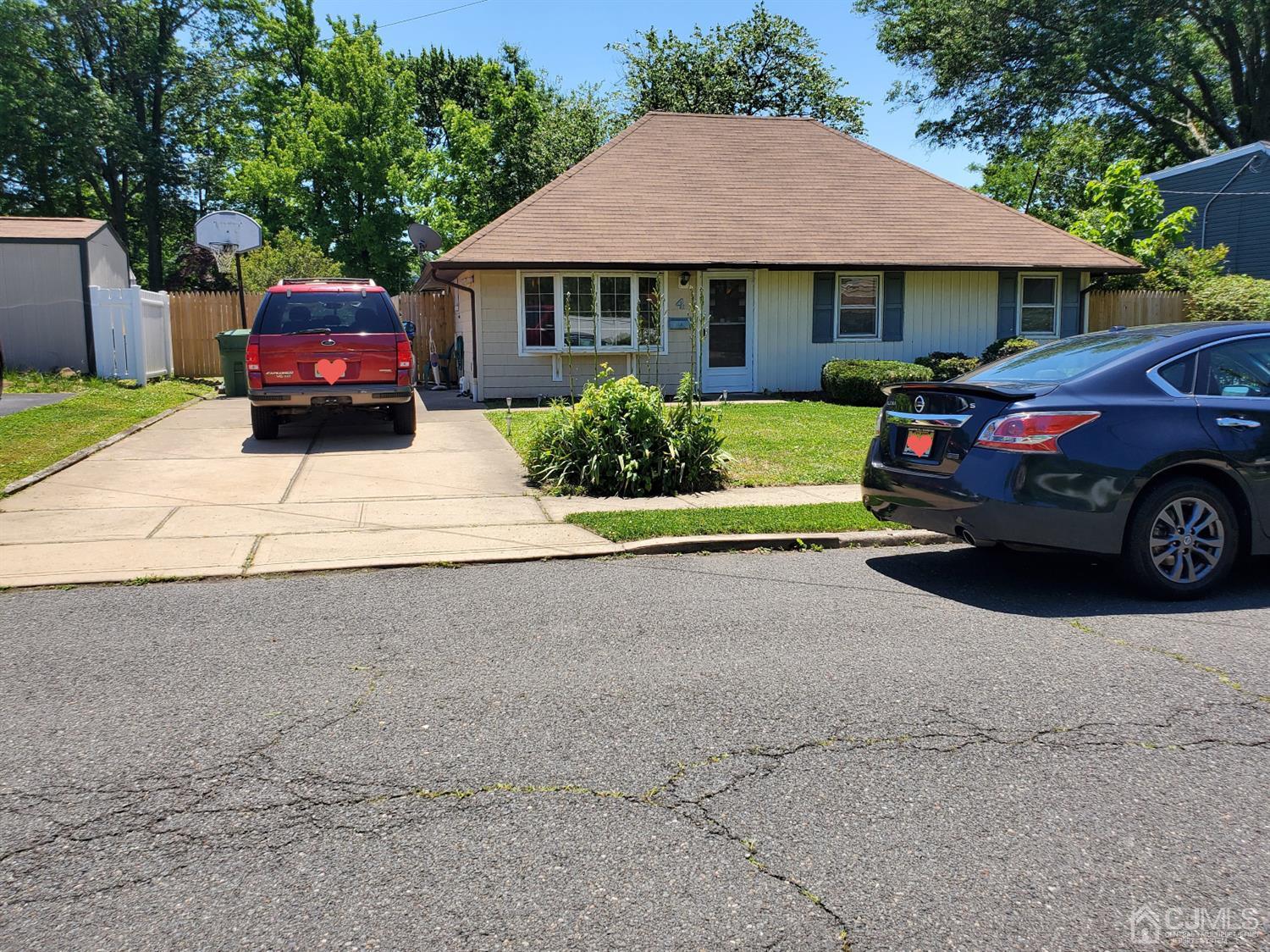 4 Mercury Road Edison, NJ 08817 - Photo 1 of 22 a front view of a house with a garden and parking