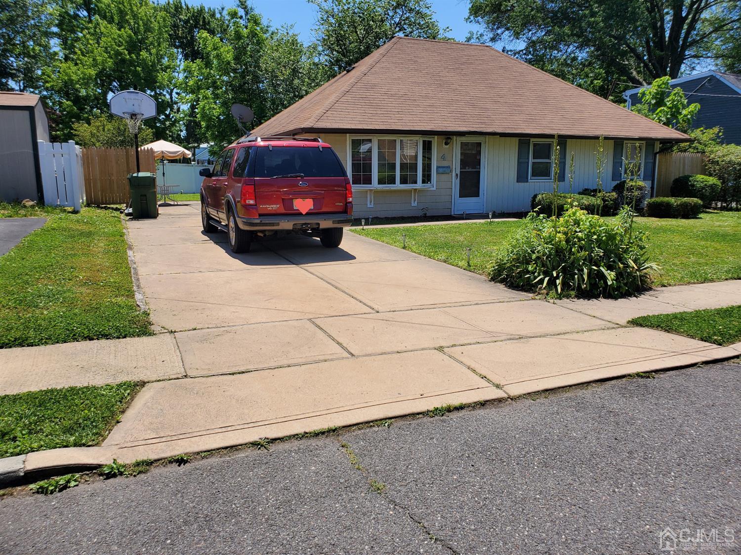4 Mercury Road Edison, NJ 08817 - Photo 2 of 22 a front view of a house with a yard and garage
