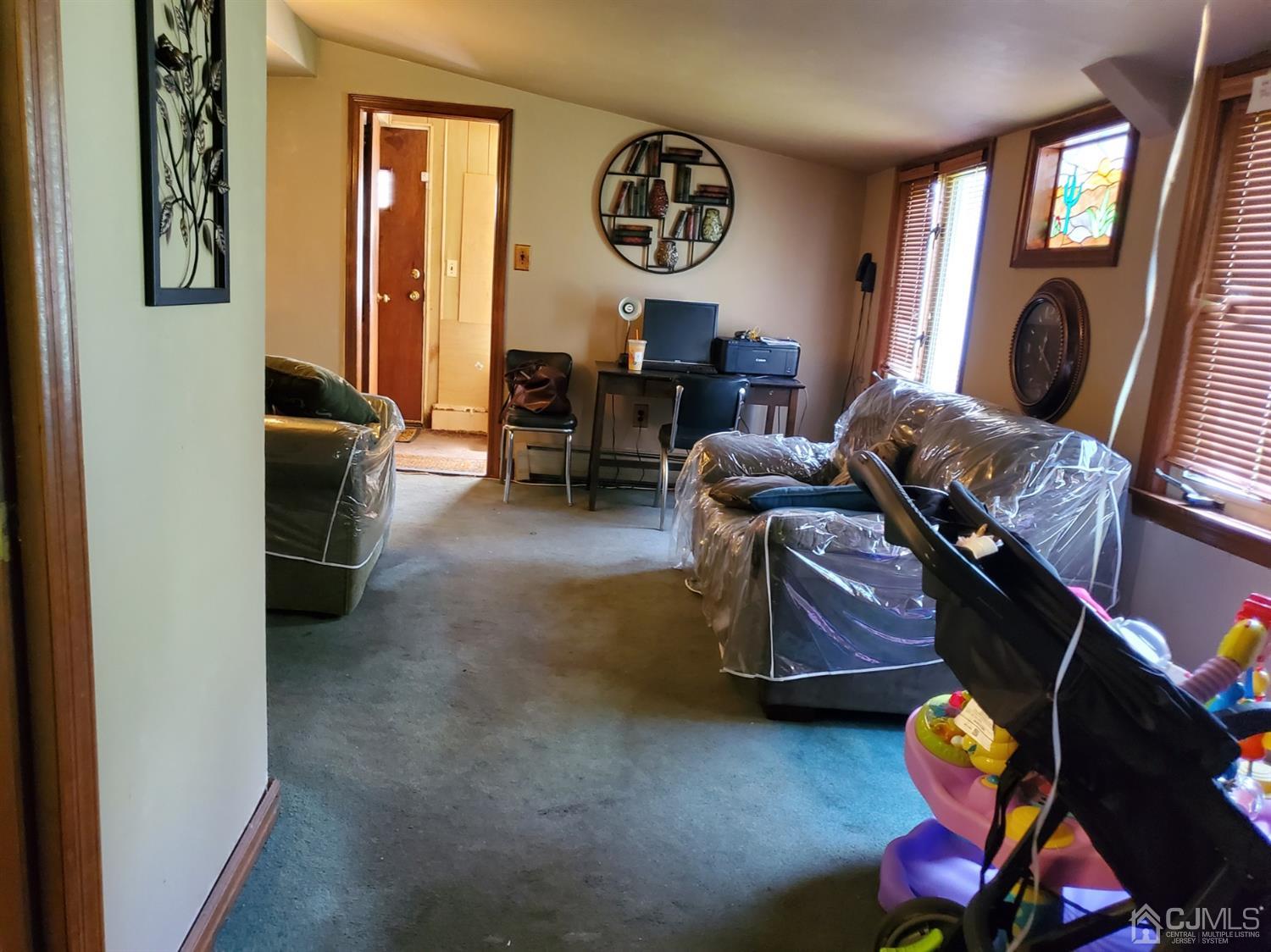 4 Mercury Road Edison, NJ 08817 - Photo 20 of 22 a living room with furniture and a fireplace