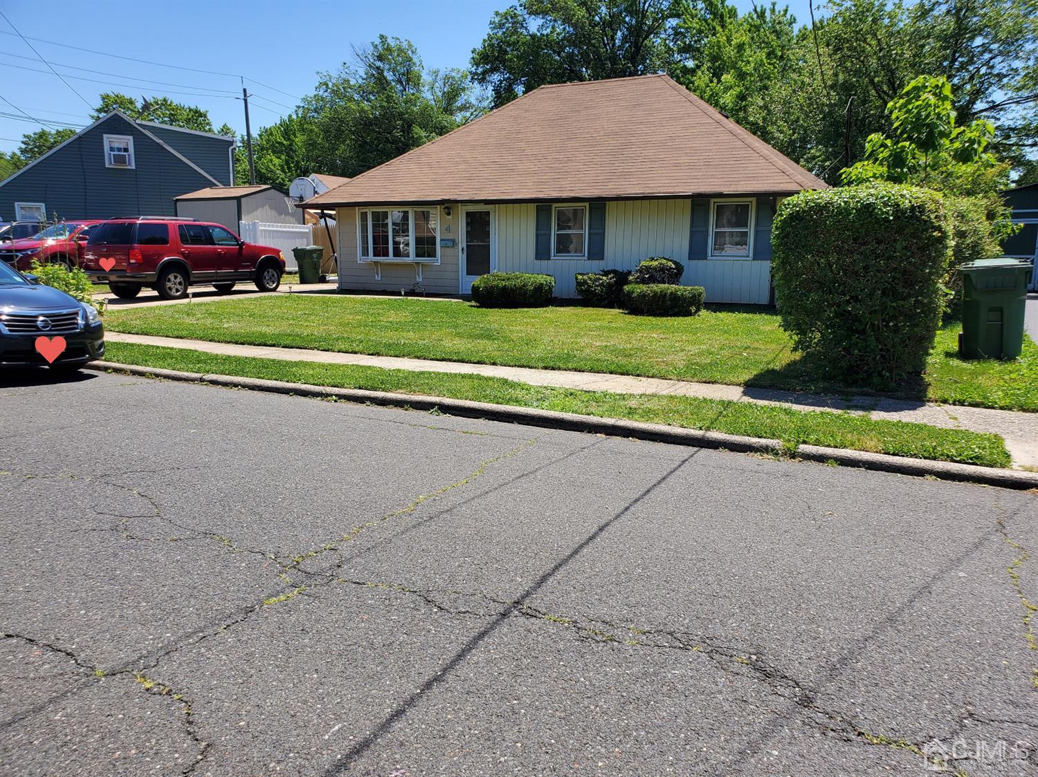 4 Mercury Road Edison, NJ 08817 - Photo 3 of 22 a front view of a house with a yard and garage