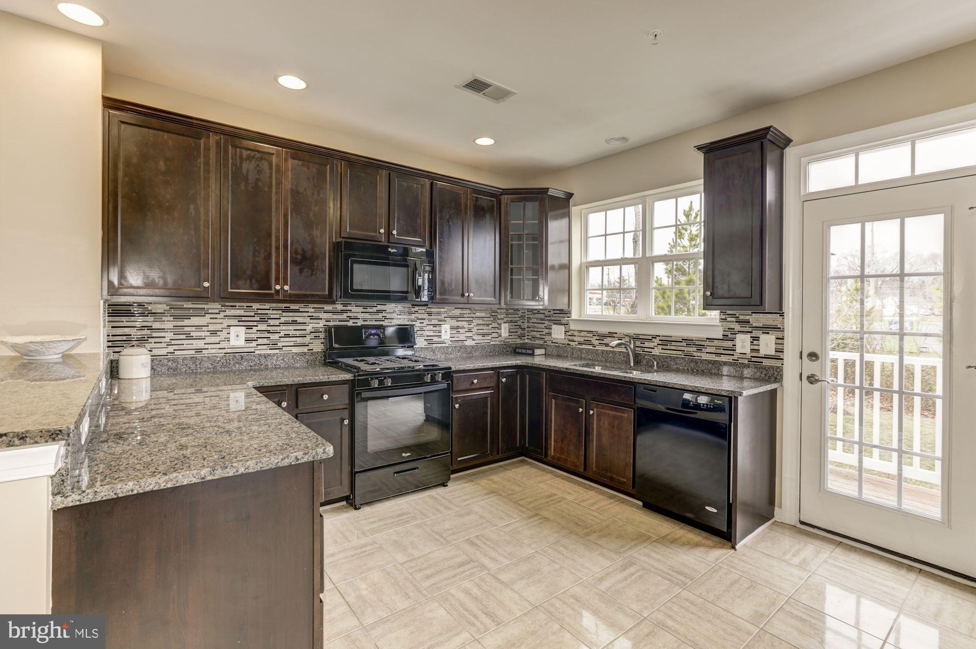 7478 Riding Meadow Way Manassas, VA 20111 - Photo 12 of 32 Granite countertops in all wood themed kitchen
