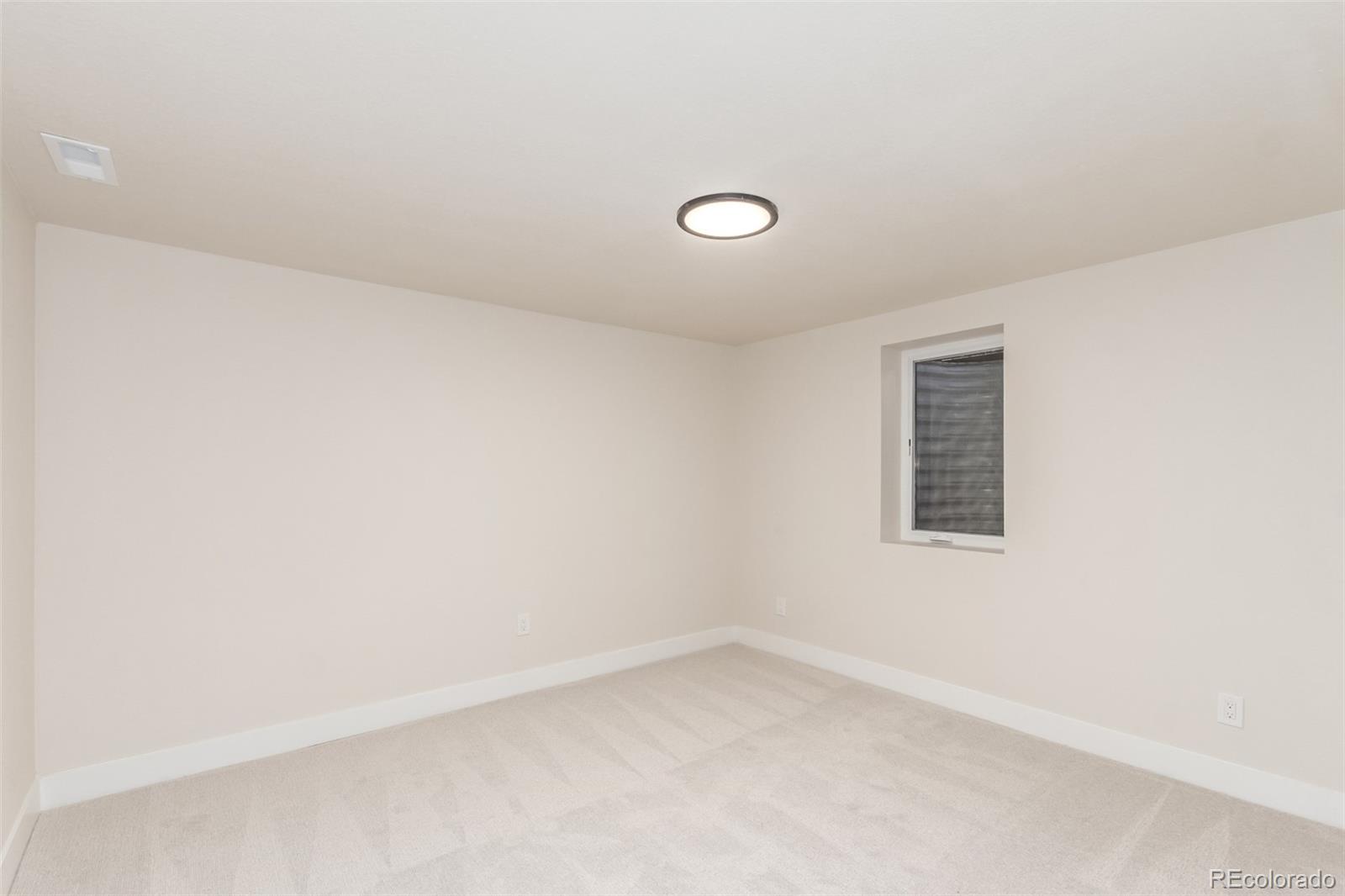 1760 South Dale Court Denver, CO 80219 - Photo 15 of 23 an empty room with a window