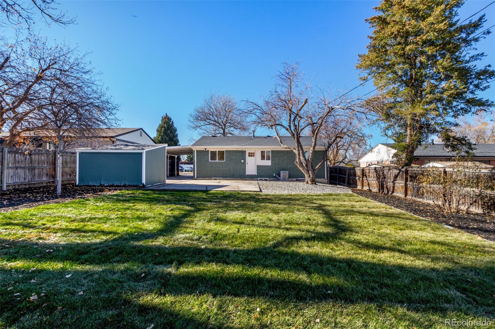 1760 South Dale Court Denver, CO 80219 - Photo 22 of 23 a swimming pool with outdoor seating and yard