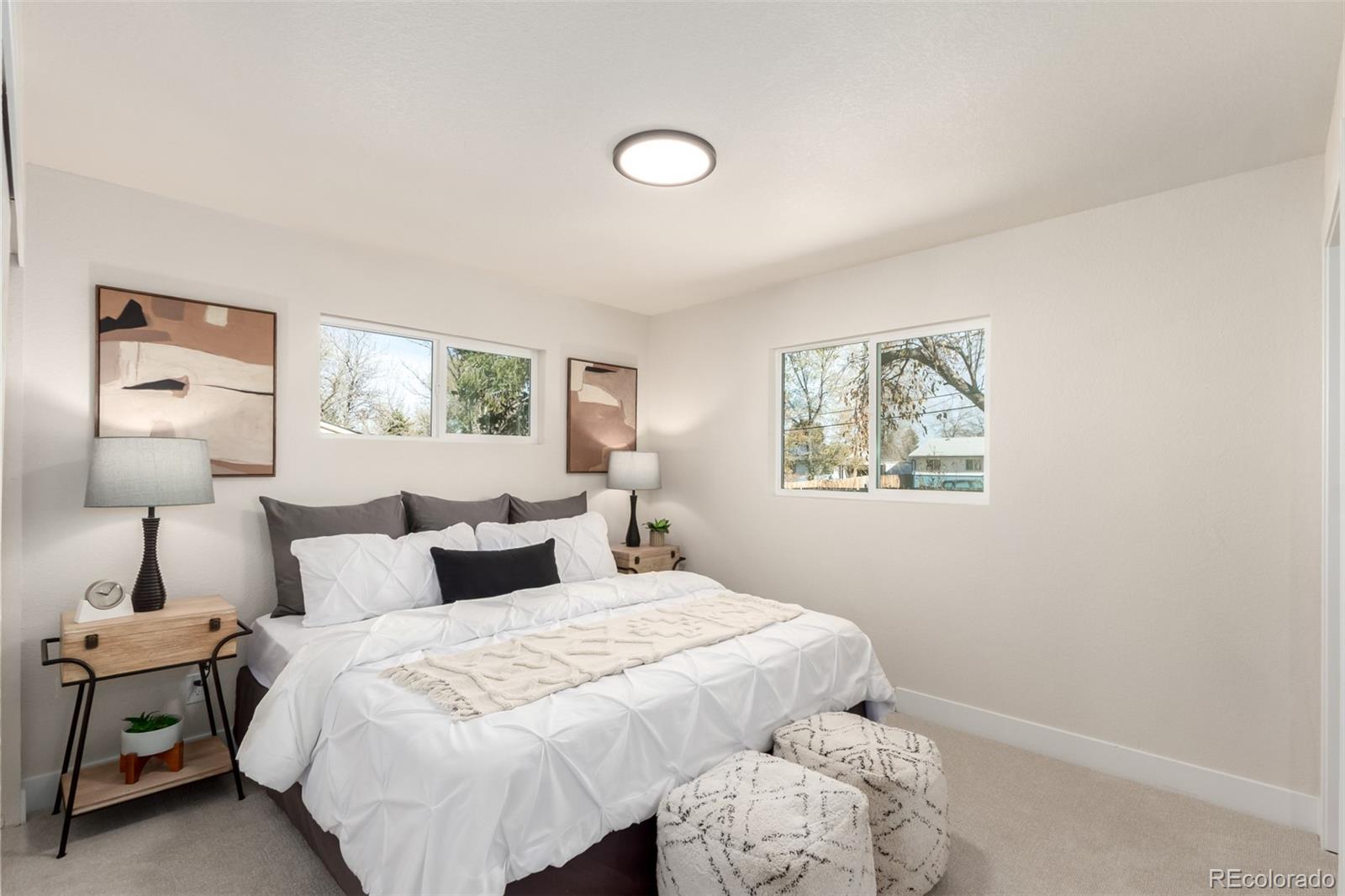 1760 South Dale Court Denver, CO 80219 - Photo 9 of 23 a bedroom with a bed and a lamp