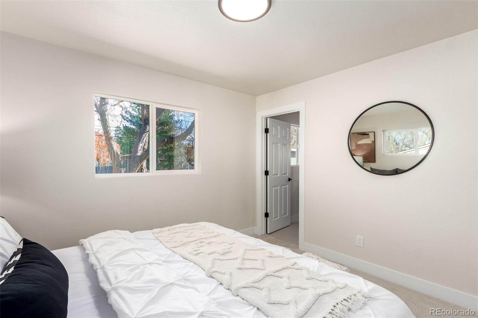 1760 South Dale Court Denver, CO 80219 - Photo 10 of 23 a bedroom with a bed and a window