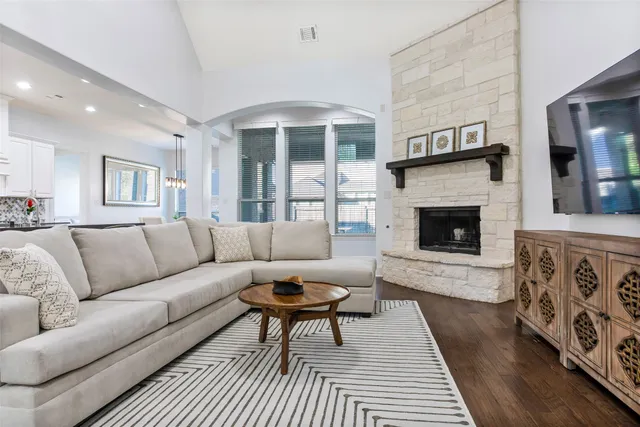 a living room with furniture a flat screen tv and a fireplace