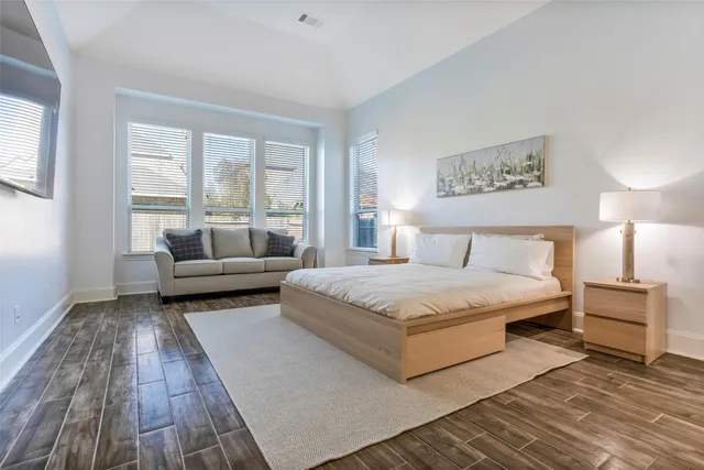 a bedroom with a bed and a couch