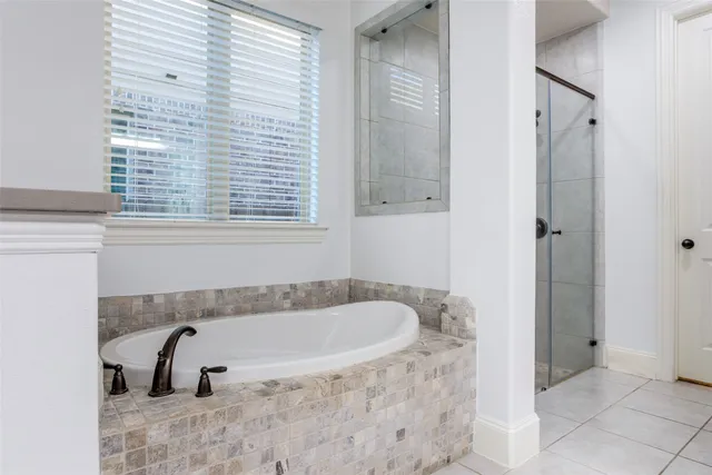 a bathroom with bathtub and window