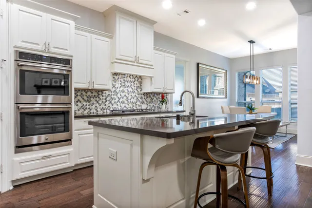 a kitchen with stainless steel appliances granite countertop a sink and cabinets