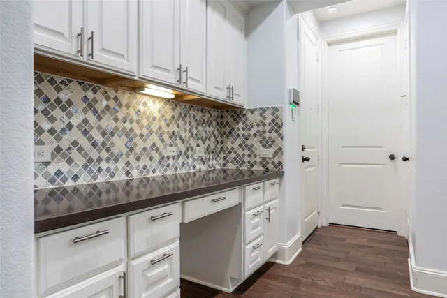 wooden floor with white cabinets