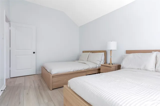 a bedroom with two beds and a night stand