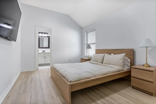 a bedroom with a bed and a view of kitchen
